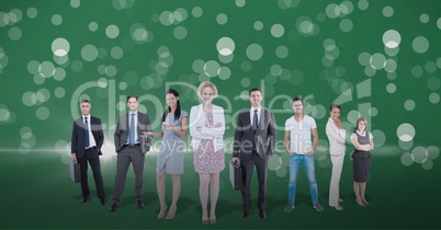 Business people standing against lens flare in green background