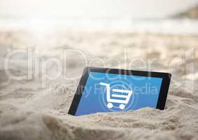 Tablet in the sand beach with Shopping trolley icon