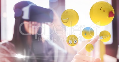 Digitally generated image of woman touching flying emojis while using VR glasses