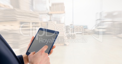 Midsection businessman using digital tablet in warehouse