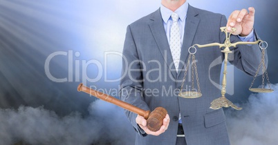 Judge with balance scale and hammer in front of clouds
