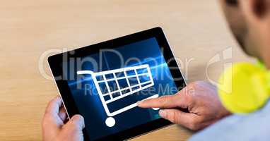 Cropped image of man touching shopping cart icons on tablet PC