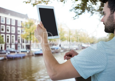 Young men on holidays with his tablet