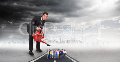 Large businessman pouring water on employees against storm clouds