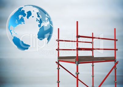 Globe next to scaffolding in blurry grey wood panel