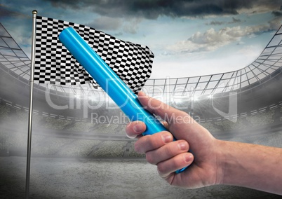 Hand with blue baton against stadium with flare and checkered flag