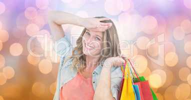 Happy woman with shopping bags over blur background
