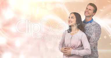 Loving couple smiling while looking away over blur background