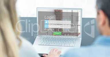 Man and woman looking at login screen on laptop