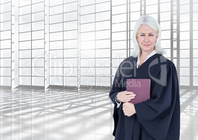 Judge holding book in front of large bright windows