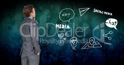 Thoughtful businessman looking at media graphics