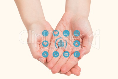 Digitally generated image of various icons on hand against beige background