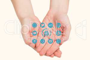 Digitally generated image of various icons on hand against beige background