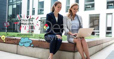 Businesswomen using laptop while sitting on retaining wall by creative process graphics