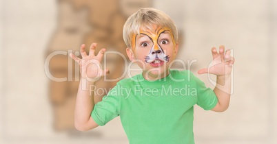 Boy with facepaint growling against blurry brown map