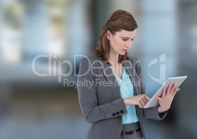 woman on tablet with blurred street background