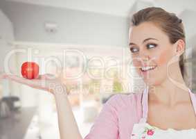 Cook woman in the kitchen of the house looking the tomato
