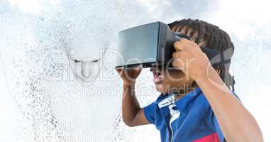 Kid in VR and 3D male shaped binary code against sky and clouds