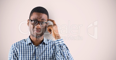 Businessman scratching head over colored background