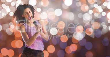 Female music artist singing over bokeh