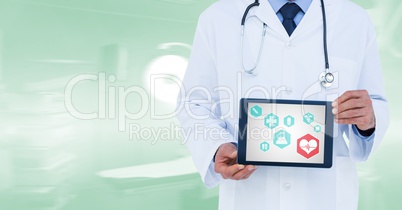 Composite image of doctor showing tablet