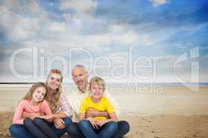Portrait of happy family at beach against sky