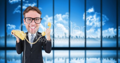 Nerd businessman holding telephone
