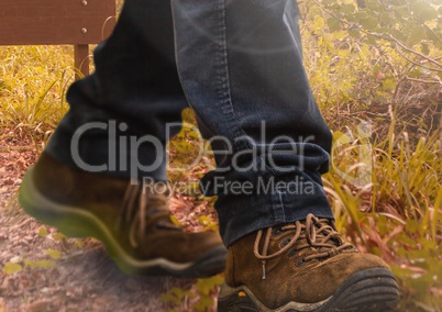 Hiking shoes walking in wild rough nature grass