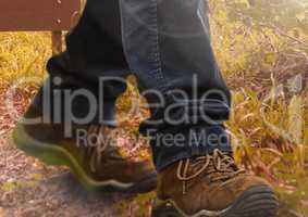 Hiking shoes walking in wild rough nature grass