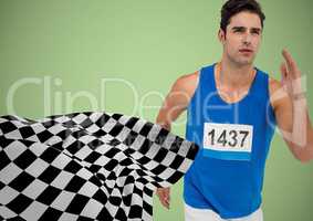 Male runner sprinting against green background and checkered flag