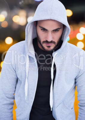 Man with hood against night city