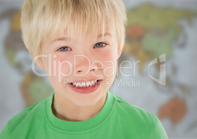 Boy smiling against blurry map