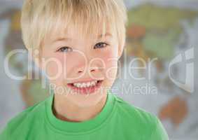 Boy smiling against blurry map