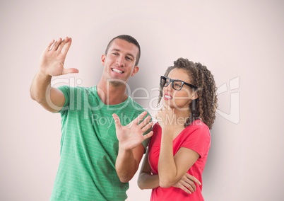 Businesswoman looking at colleague gesturing over colored background
