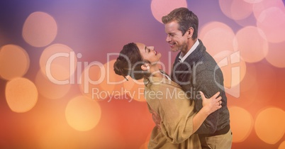 Loving couple embracing over blur background