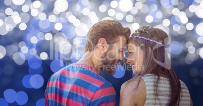 Rear view of couple smiling over bokeh