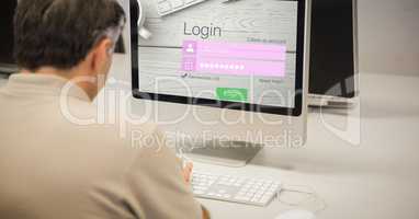 Rear view of businessman logging in on site using computer