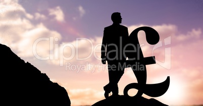 Silhouette businessman leaning on pound symbol against sky during sunset