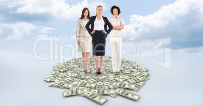 Digital composite image of businesswomen standing on dollar bills against cloudy sky