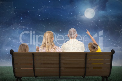 Composite image of family watching the moon