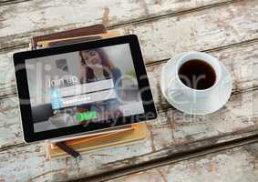coffee with tablet and books. Log in on the screen.