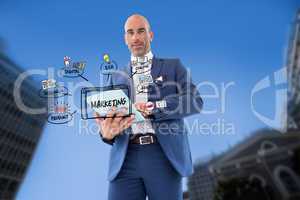 Businessman using tablet PC with marketing icons in city