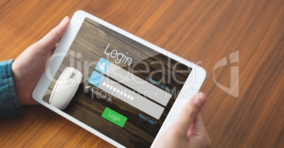 Hands holding tablet PC with log in page on screen
