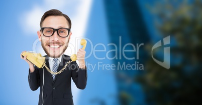 Nerd businessman holding telephone