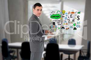 Digitally generated image of businessman using laptop with various icons in office