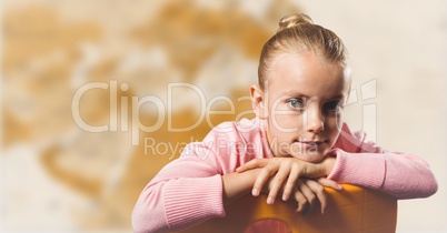 Girl on chair against blurry brown map