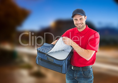 Happy pizza deliveryman with delivery bag in the city at evening