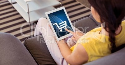 Woman touching shopping cart icon on tablet PC