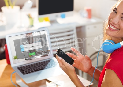 Happy woman in the work with laptop and phone. The screen of the laptop is login