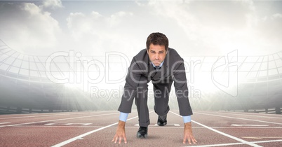 Digitally generated image of businessman at starting point on racing track
